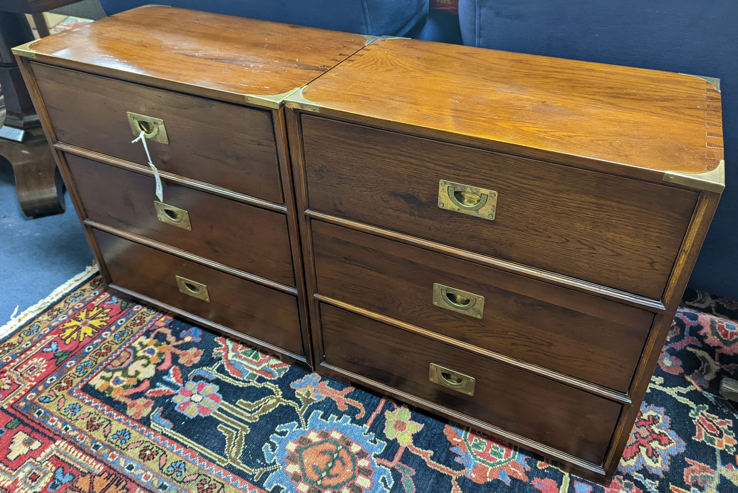 A pair of reproduction oak brass mounted military style bedside chests, width 58cm, depth 35cm, height 61cm